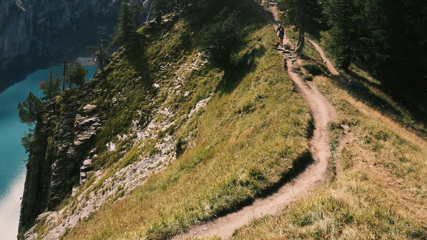 A high mountain path with Oeschinen Lake below